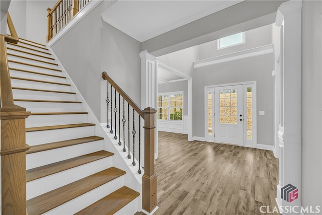 foyer featuring crown molding and light wood-type flooring