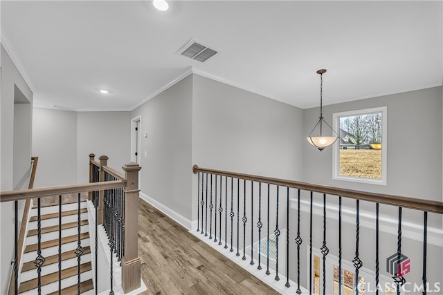 hall featuring ornamental molding and light hardwood / wood-style flooring