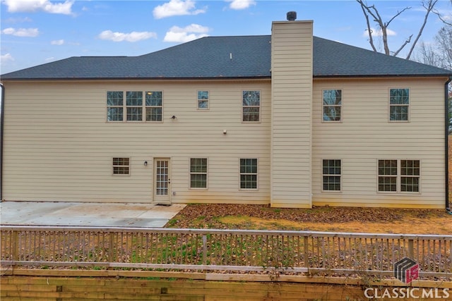 back of property with a patio