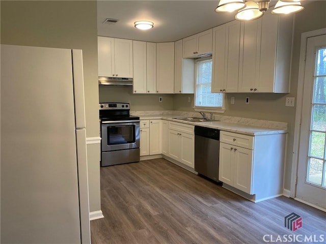 kitchen with sink, white cabinets, stainless steel appliances, and dark hardwood / wood-style floors