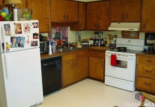 kitchen with sink and white appliances