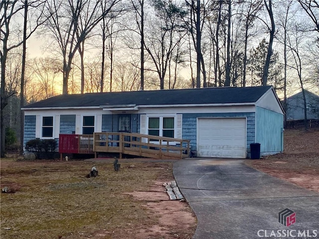 single story home with a garage and a wooden deck