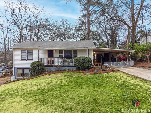 view of front of house with a front lawn, a porch, and a carport