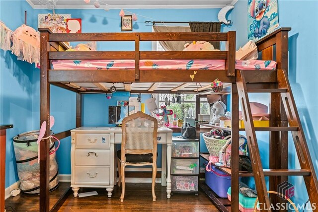 bedroom featuring dark hardwood / wood-style floors and crown molding