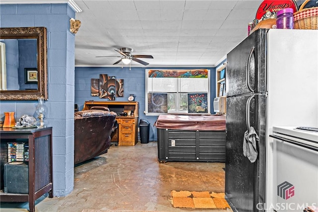 kitchen with concrete flooring, ceiling fan, and black refrigerator