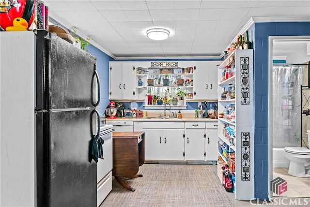 kitchen featuring white cabinetry, sink, crown molding, stove, and fridge