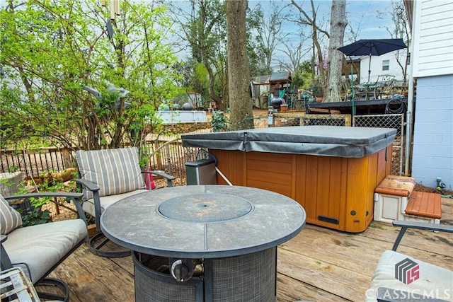 wooden terrace featuring a hot tub