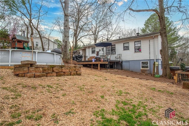 rear view of house with a swimming pool side deck