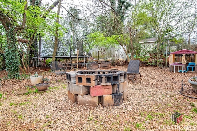 view of yard with a fire pit