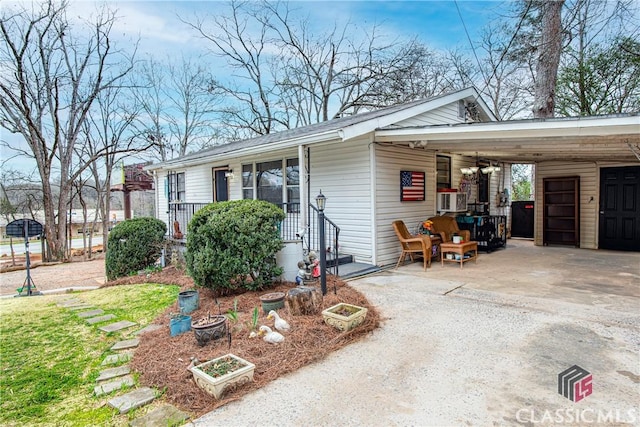 view of side of property featuring a carport and cooling unit