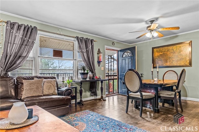 dining space with ceiling fan, crown molding, and dark wood-type flooring