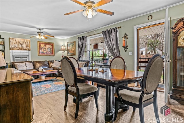 dining area with ceiling fan, light hardwood / wood-style floors, and crown molding