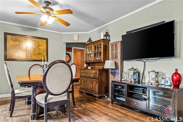 dining space featuring ceiling fan, dark wood-type flooring, and ornamental molding