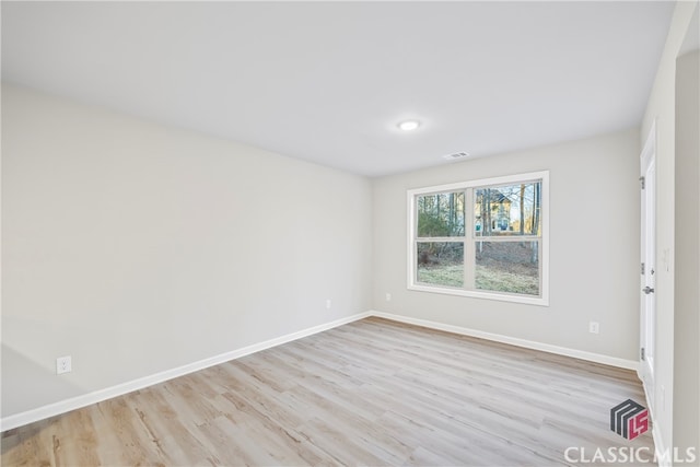 spare room with light hardwood / wood-style floors