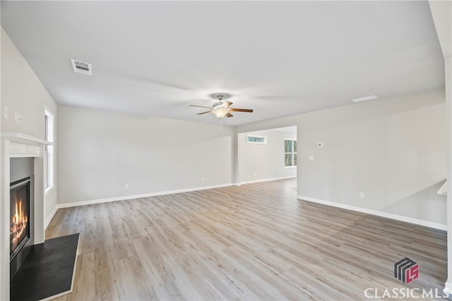 unfurnished living room with ceiling fan and light wood-type flooring