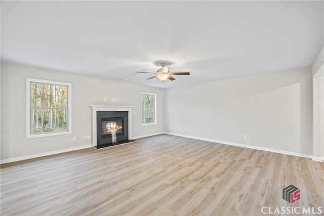 unfurnished living room with light hardwood / wood-style floors and ceiling fan