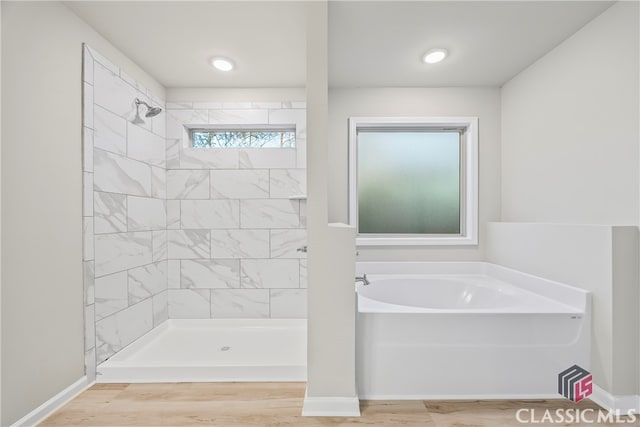 bathroom featuring separate shower and tub and a wealth of natural light