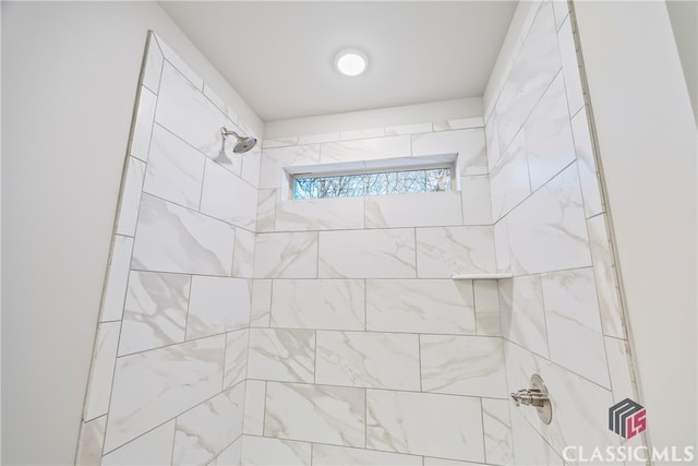 bathroom with a tile shower