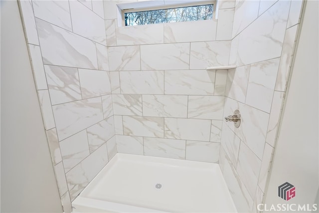 bathroom with a tile shower