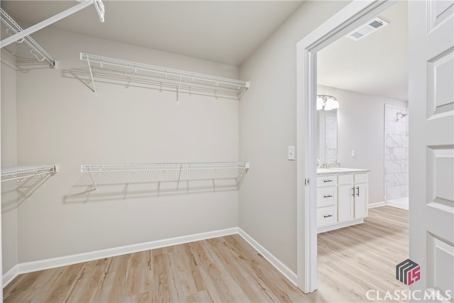 walk in closet featuring light hardwood / wood-style floors