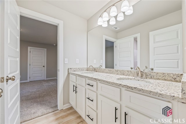 bathroom with hardwood / wood-style floors and vanity