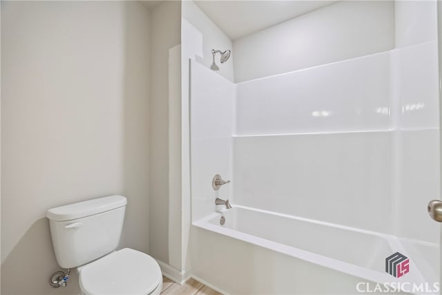 bathroom featuring toilet and bathtub / shower combination