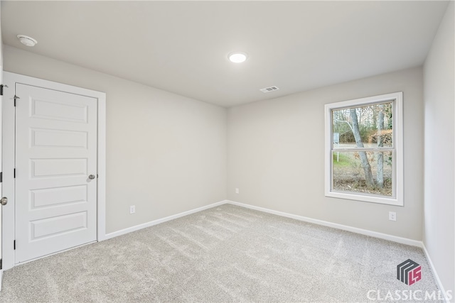 empty room with light colored carpet