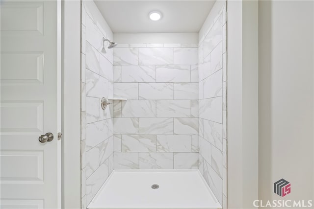 bathroom with a tile shower