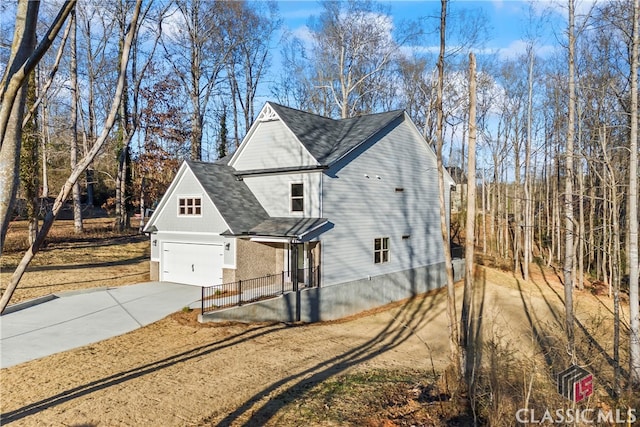 view of side of home featuring a garage