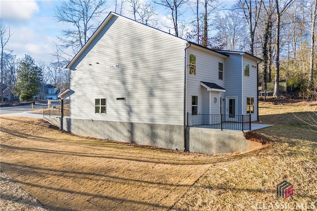 view of side of property with a patio area