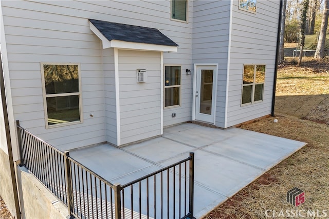 view of exterior entry with a patio area