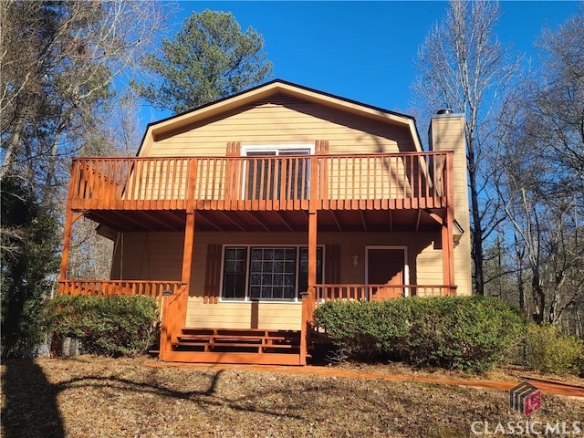 back of house featuring a deck