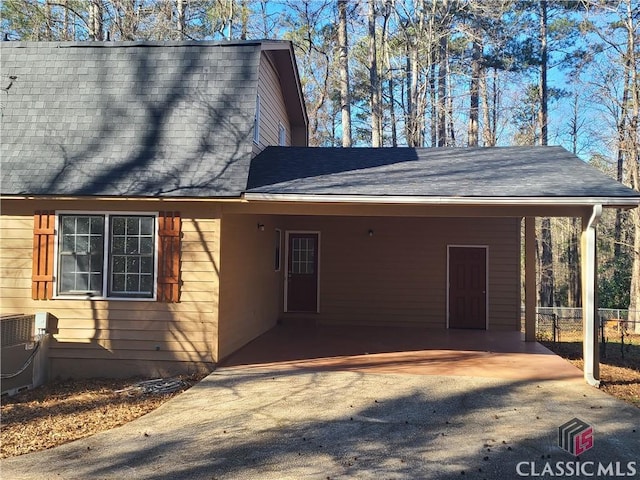 view of property exterior with a carport and cooling unit