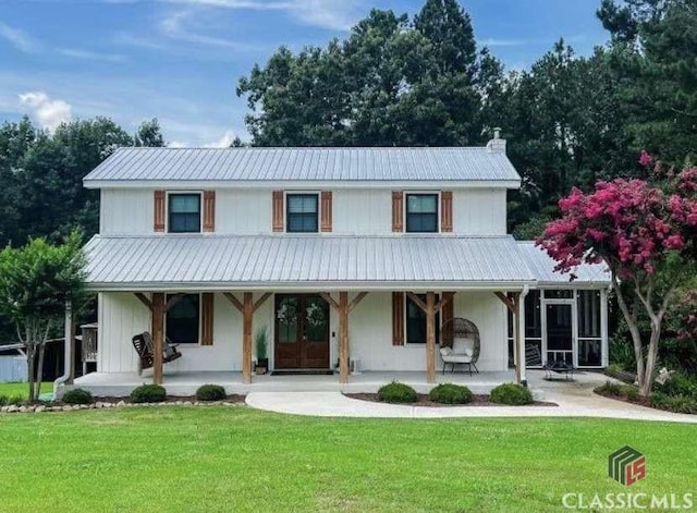 view of front of home featuring a porch, a front yard, and french doors