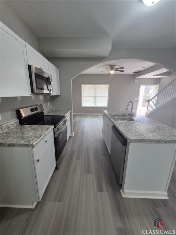 kitchen featuring white cabinetry, sink, ceiling fan, a healthy amount of sunlight, and appliances with stainless steel finishes