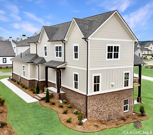 1745 Silo Bnd Unit 16, Watkinsville, GA 30677 - view of side of home with a lawn, brick siding, a residential view, and a shingled roof