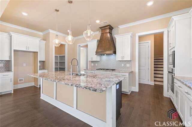 1745 Silo Bnd Unit 16, Watkinsville, GA 30677 - kitchen with premium range hood, an island with sink, a sink, dark wood-style floors, and appliances with stainless steel finishes