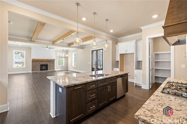 1745 Silo Bnd Unit 16, Watkinsville, GA 30677 - kitchen with dark wood-type flooring, a sink, white cabinetry, appliances with stainless steel finishes, and a brick fireplace