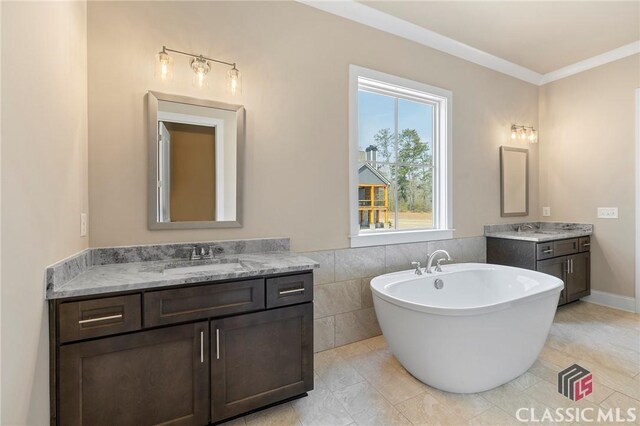 1745 Silo Bnd Unit 16, Watkinsville, GA 30677 - bathroom with a freestanding tub, crown molding, two vanities, and a sink