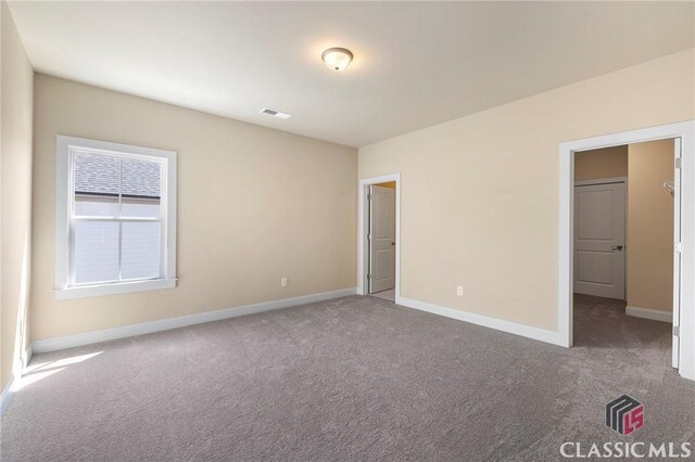 1745 Silo Bnd Unit 16, Watkinsville, GA 30677 - unfurnished bedroom featuring carpet flooring, baseboards, and visible vents