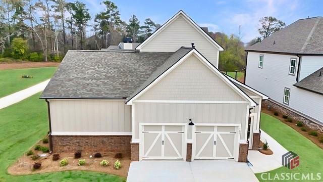 1745 Silo Bnd Unit 16, Watkinsville, GA 30677 - view of front of property featuring an attached garage, concrete driveway, roof with shingles, and a front yard