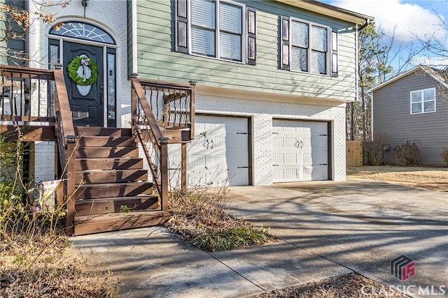 doorway to property with a garage