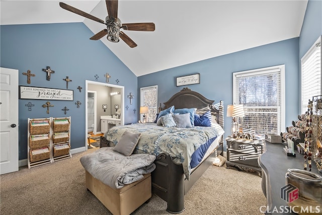 carpeted bedroom featuring high vaulted ceiling, ensuite bath, and ceiling fan