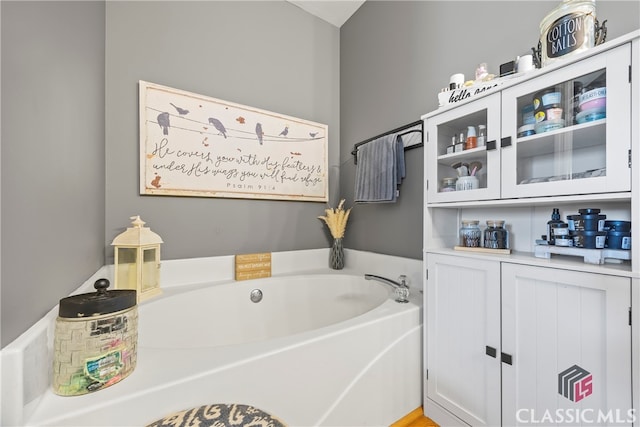 bathroom featuring a tub to relax in