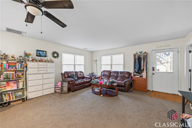 living room with carpet flooring, ceiling fan, and a healthy amount of sunlight