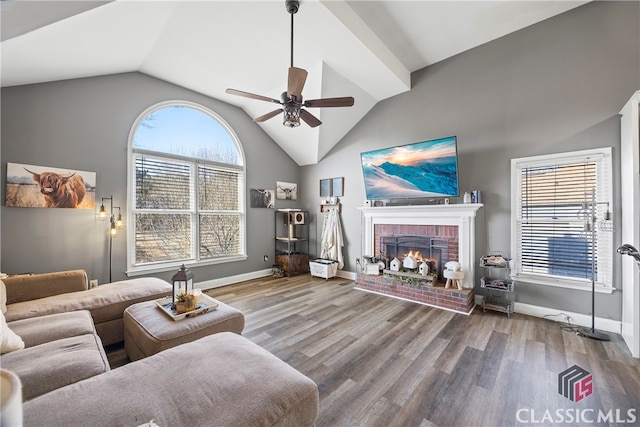 living room featuring ceiling fan, a healthy amount of sunlight, lofted ceiling, and a fireplace