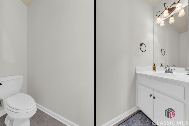 bathroom featuring tile patterned flooring, vanity, and toilet