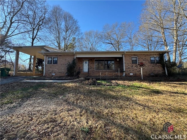 single story home with a porch and a carport