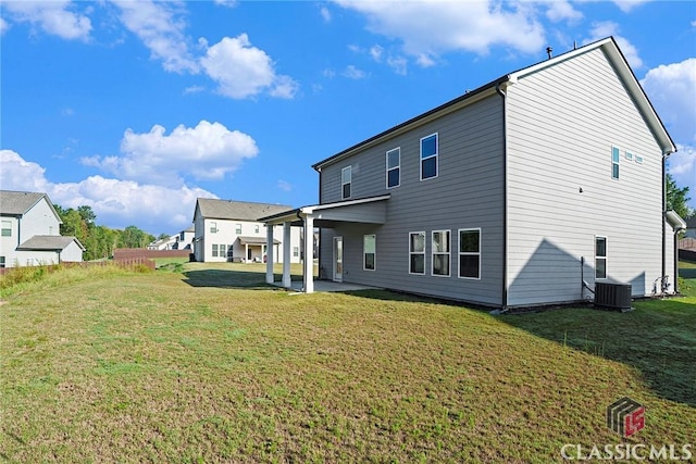 back of property featuring central air condition unit, a patio area, and a yard