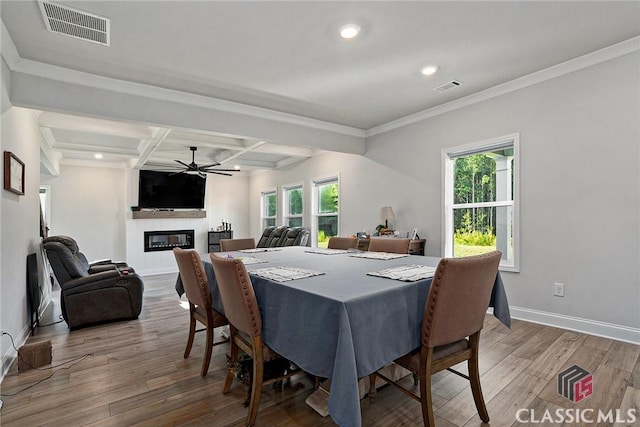 dining room with ornamental molding, coffered ceiling, ceiling fan, beam ceiling, and wood-type flooring